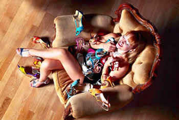 image of lady sat cuddling lots of shoes